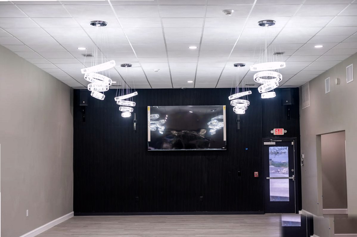 Onyx Event Center — black feature wall with spiral chandeliers and gray flooring
