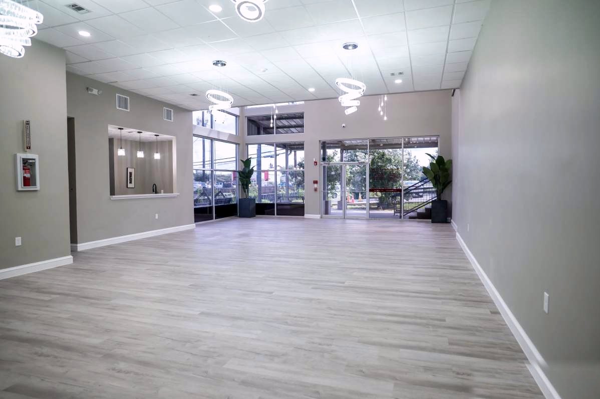 The Onyx Event Center — open main hall with glass entry, spiral chandeliers, and light gray flooring